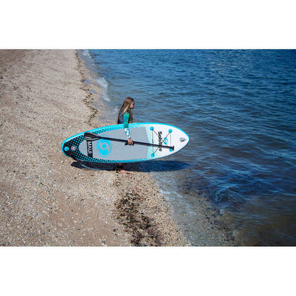 Child holding Solstice Watersports 8' Maui Youth Inflatable Stand-Up Paddleboard by the water.