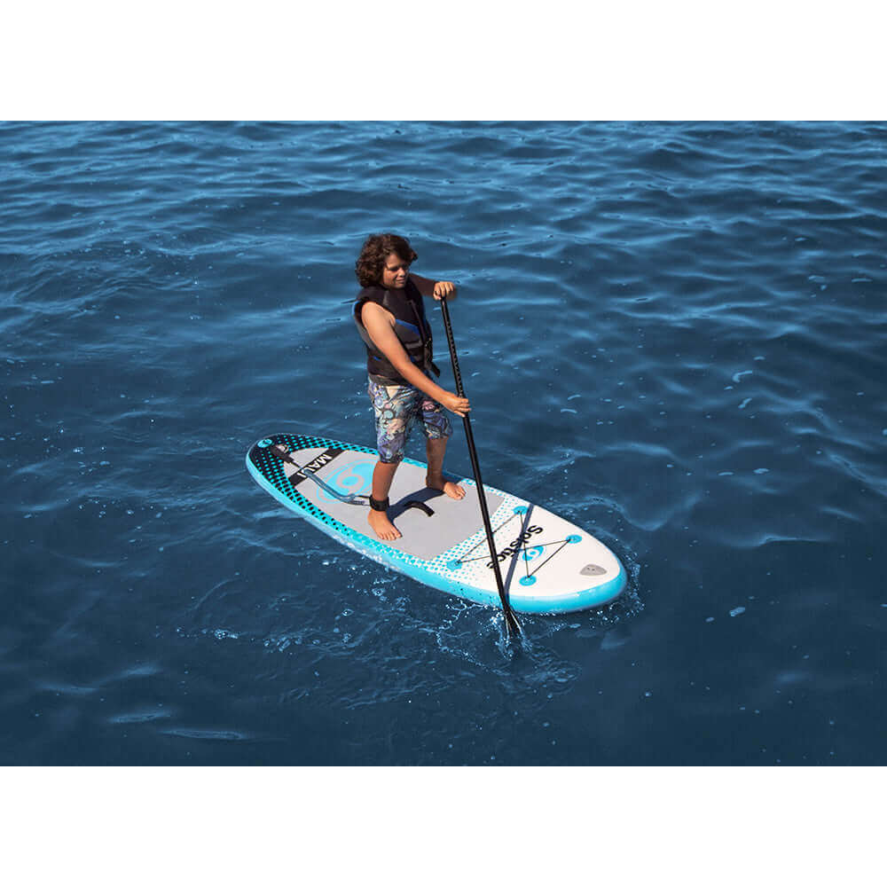 Child paddling on Solstice Watersports 8 Maui Youth Inflatable Stand-Up Paddleboard in ocean.