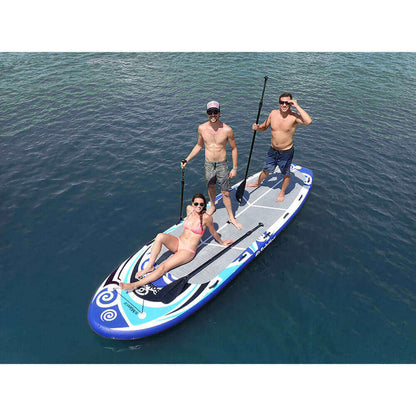 Group enjoying the water on a Solstice Maori Giant inflatable paddleboard with paddles.